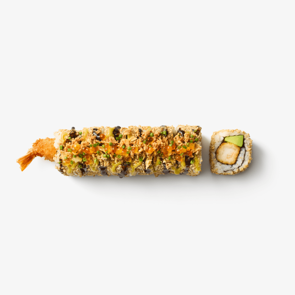 A sushi roll topped with crunchy bits and orange fish roe, with a piece of tempura shrimp tail sticking out on one end. One cut piece reveals shrimp, avocado, and rice wrapped in seaweed.