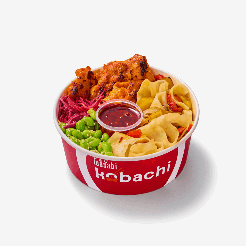A red bowl labeled “Wasabi Habachi” filled with grilled chicken, edamame, pickled red cabbage, dumplings, noodles, and a container of sauce, all arranged on a white background.